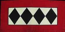 A wide barn red border, antique ivory back ground and black diamond center.